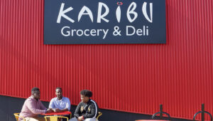 Men sitting outside Karibu store