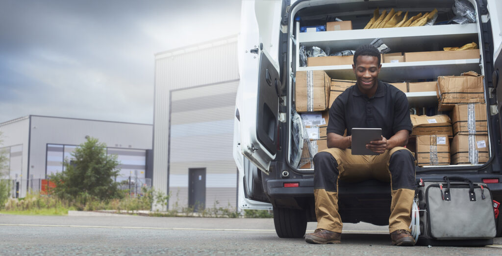 Service engineer sat at the back of his van