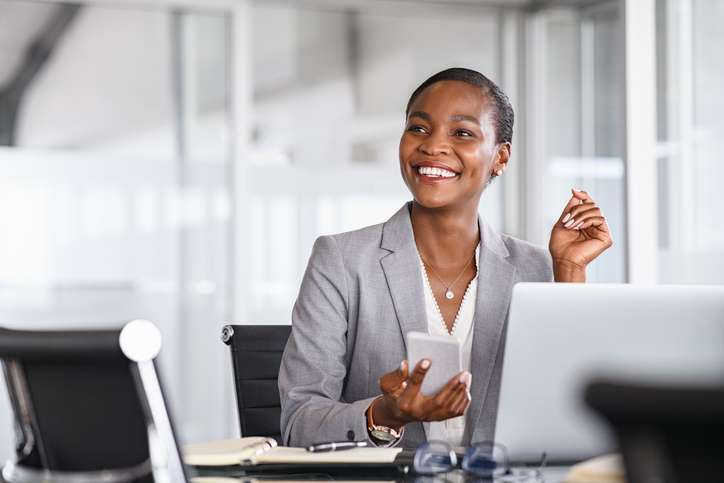 Smiling businesswoman looking up while working