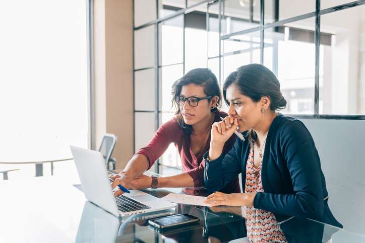 two women looking at computer screen