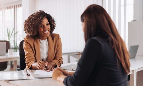 Female financial consultant manager talking with a client at the bank