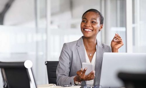 Smiling businesswoman looking up while working